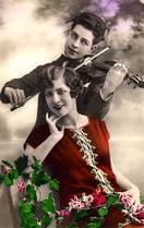 Vintage photo of a man playing a violin for a woman.